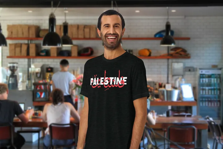 Palestine Tee, worn in a café